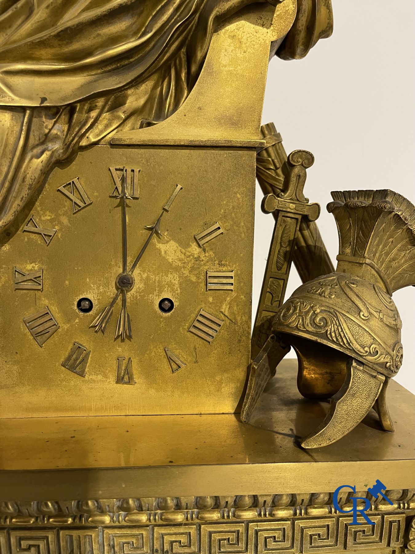 Imposing fire-gilded empire pendulum depicting a seated Roman emperor.