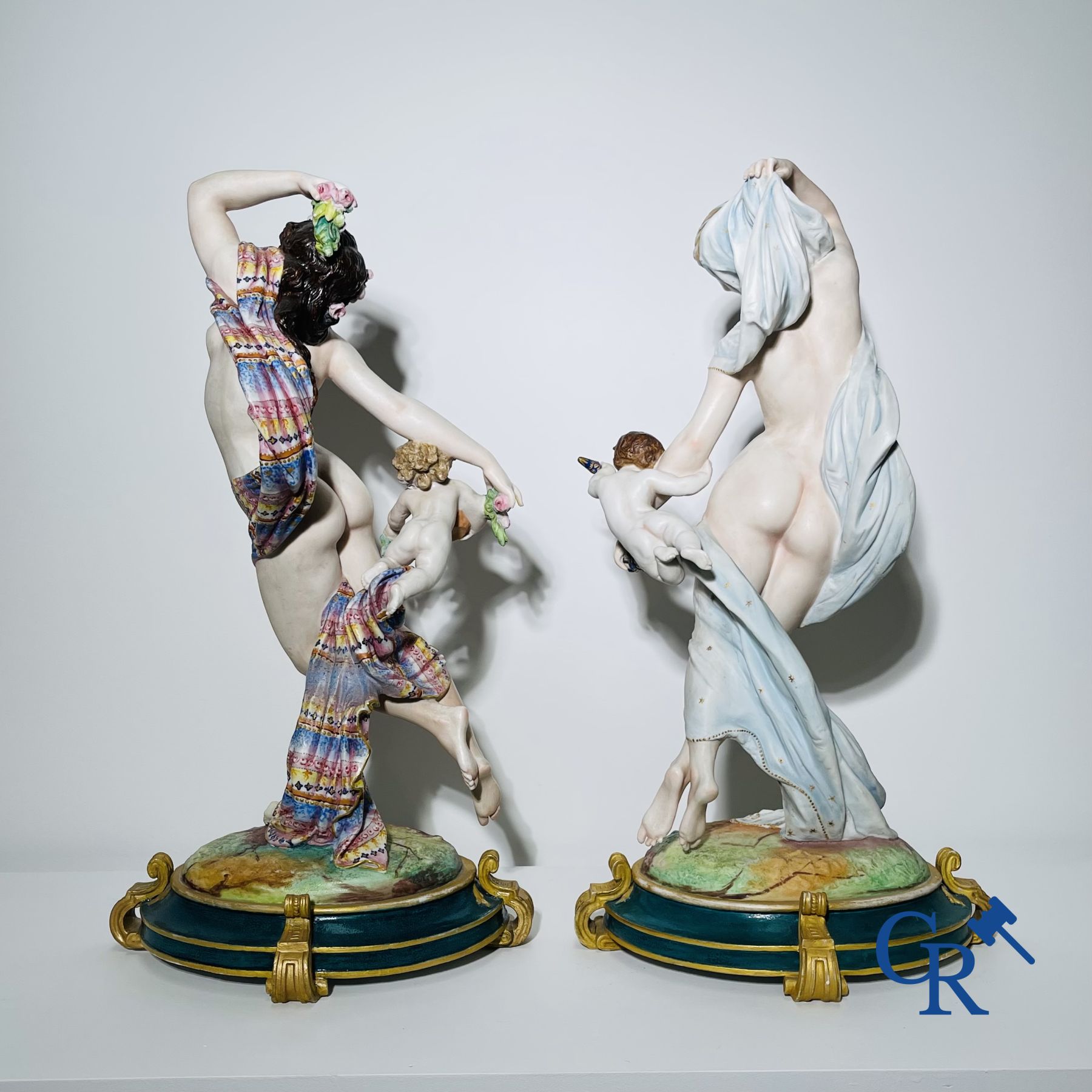 Porcelain: Large pair of multi-coloured decorated and gilded statues in biscuit with the representation of "Day and Night".